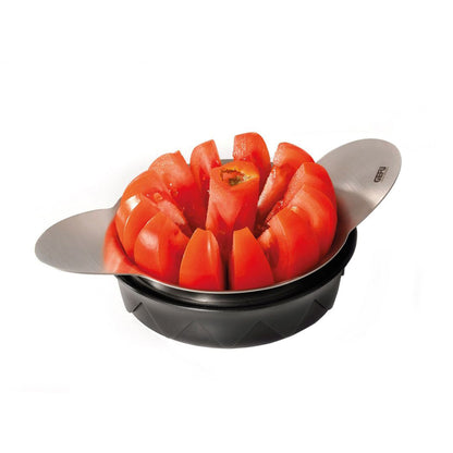 Tomato and apple slicer with black base holding sliced red tomatoes