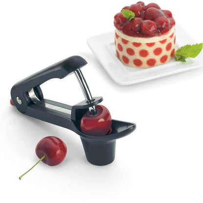 Handheld cherry and olive pitter releasing a pitted cherry into the red cup