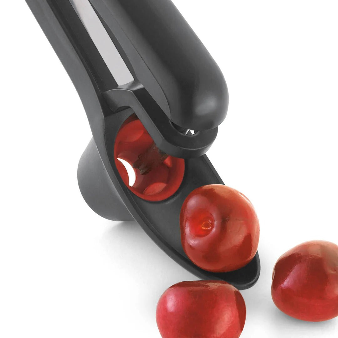 Close-up side view of cherry and olive pitter with red inner chamber
