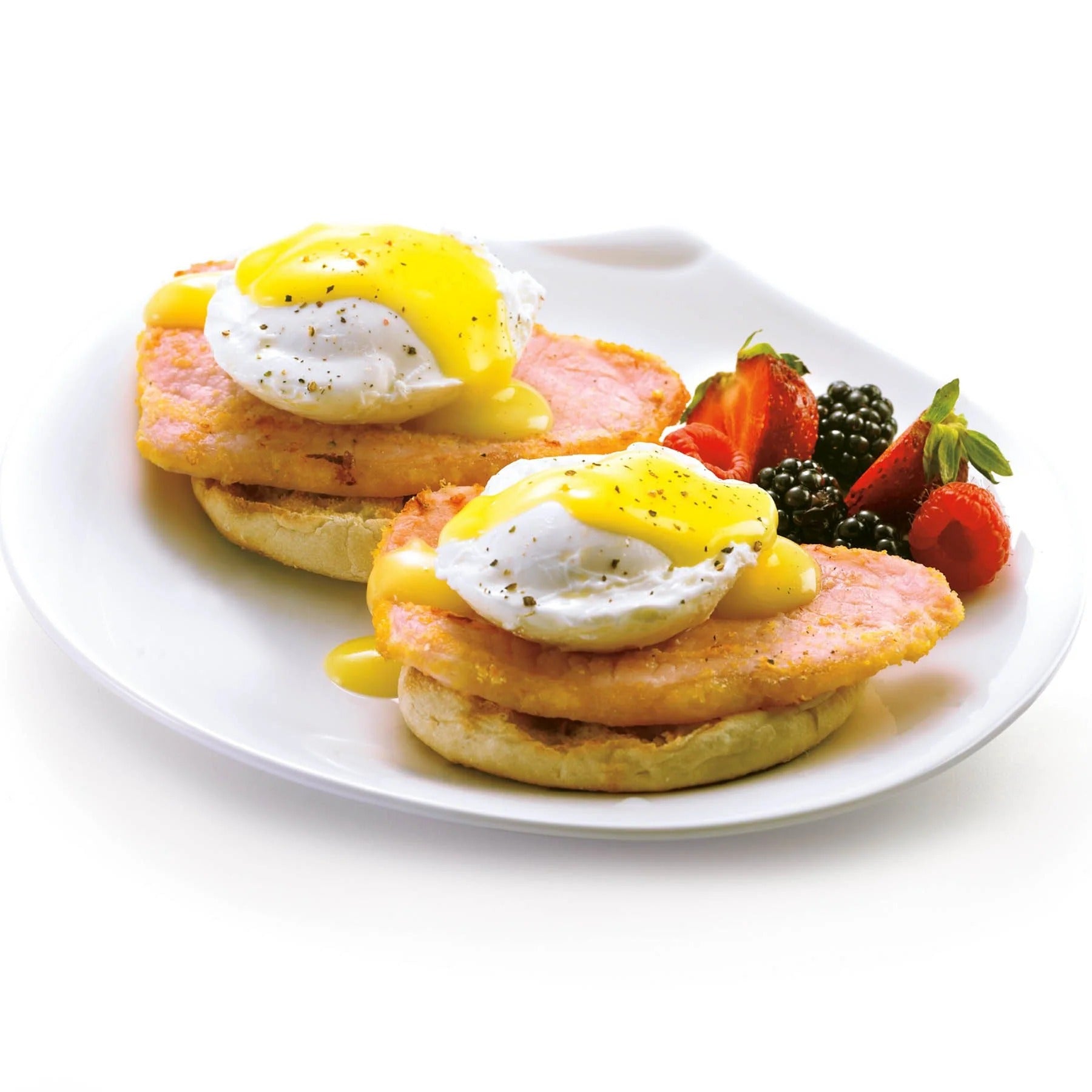 Poached eggs with runny yolks on a white plate