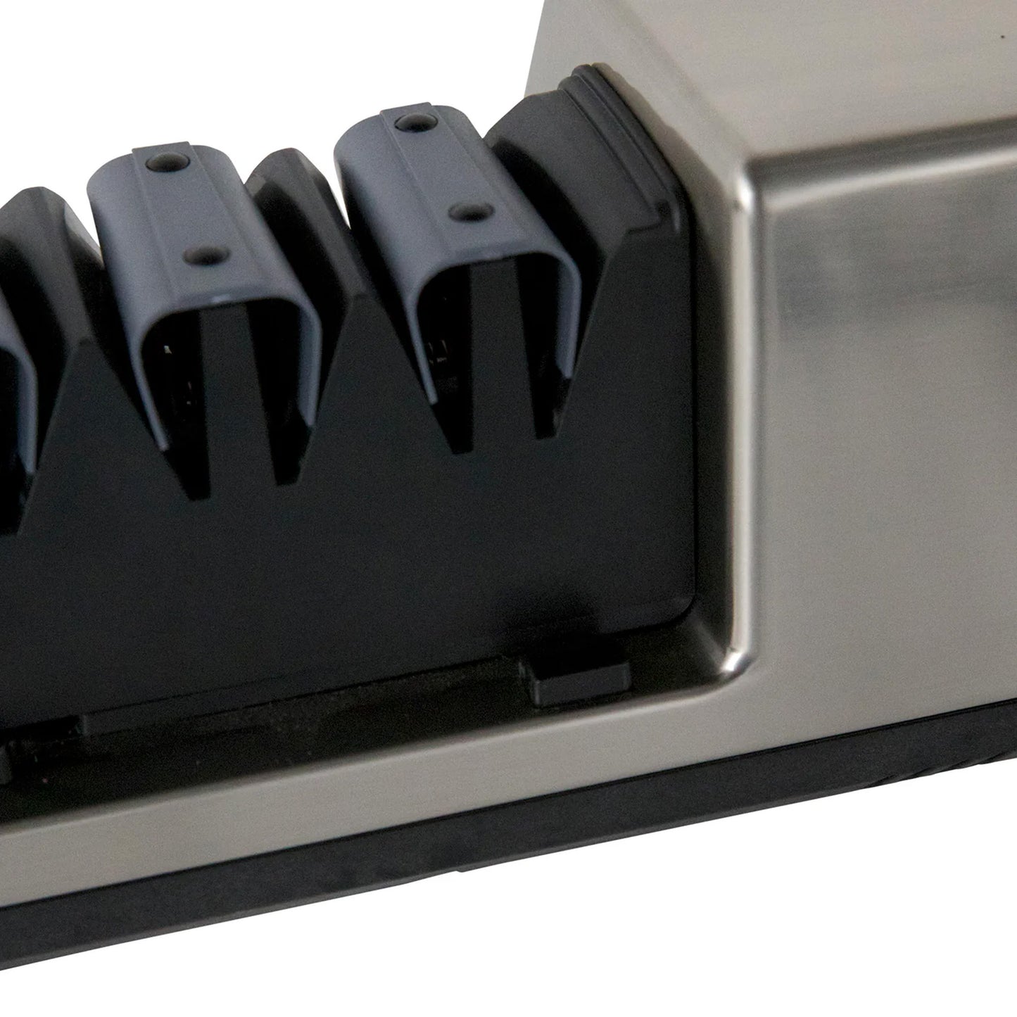 Close-up of black sharpening heads inside silver housing on a commercial sharpener