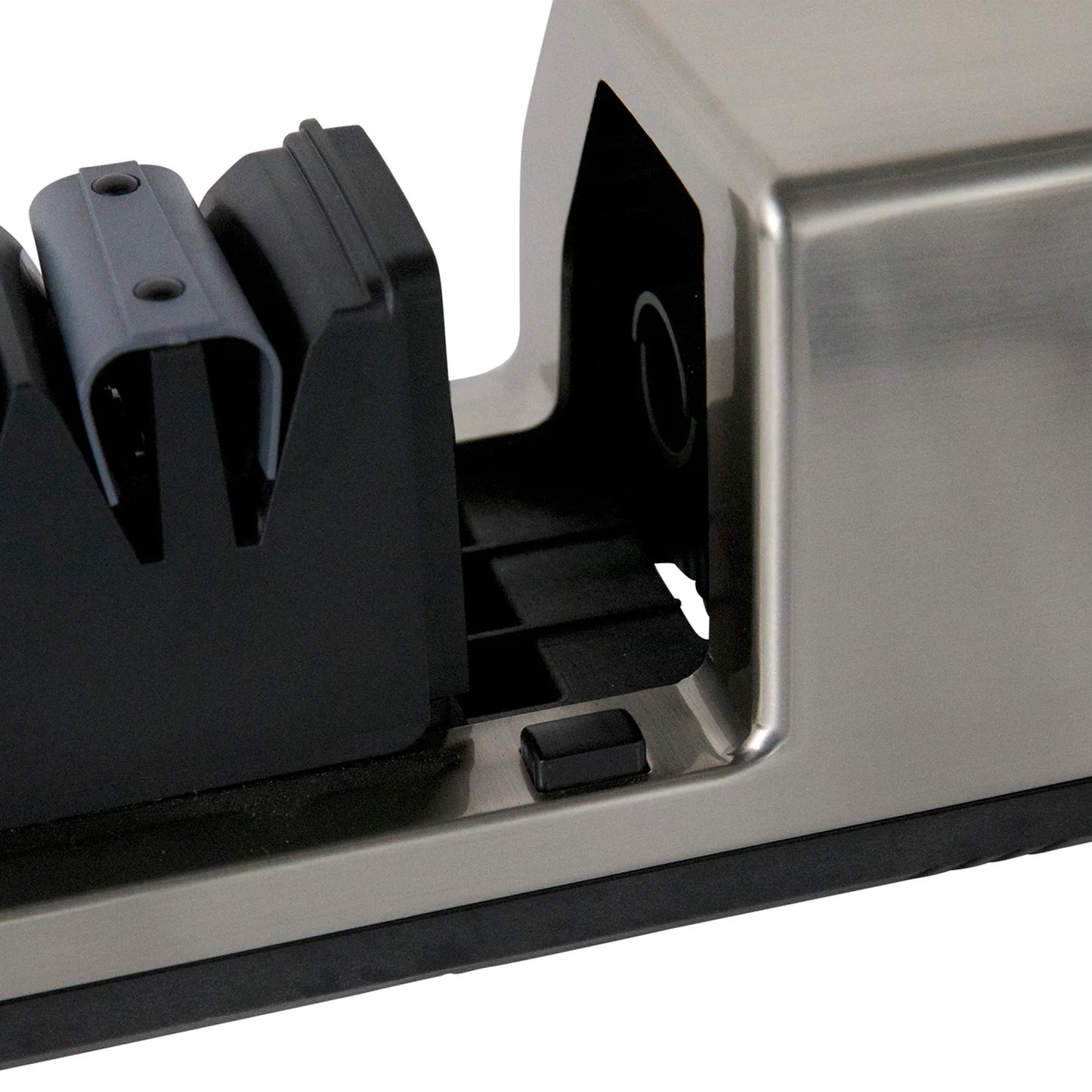 Close-up of black sharpening guide openings in silver housing on knife sharpener