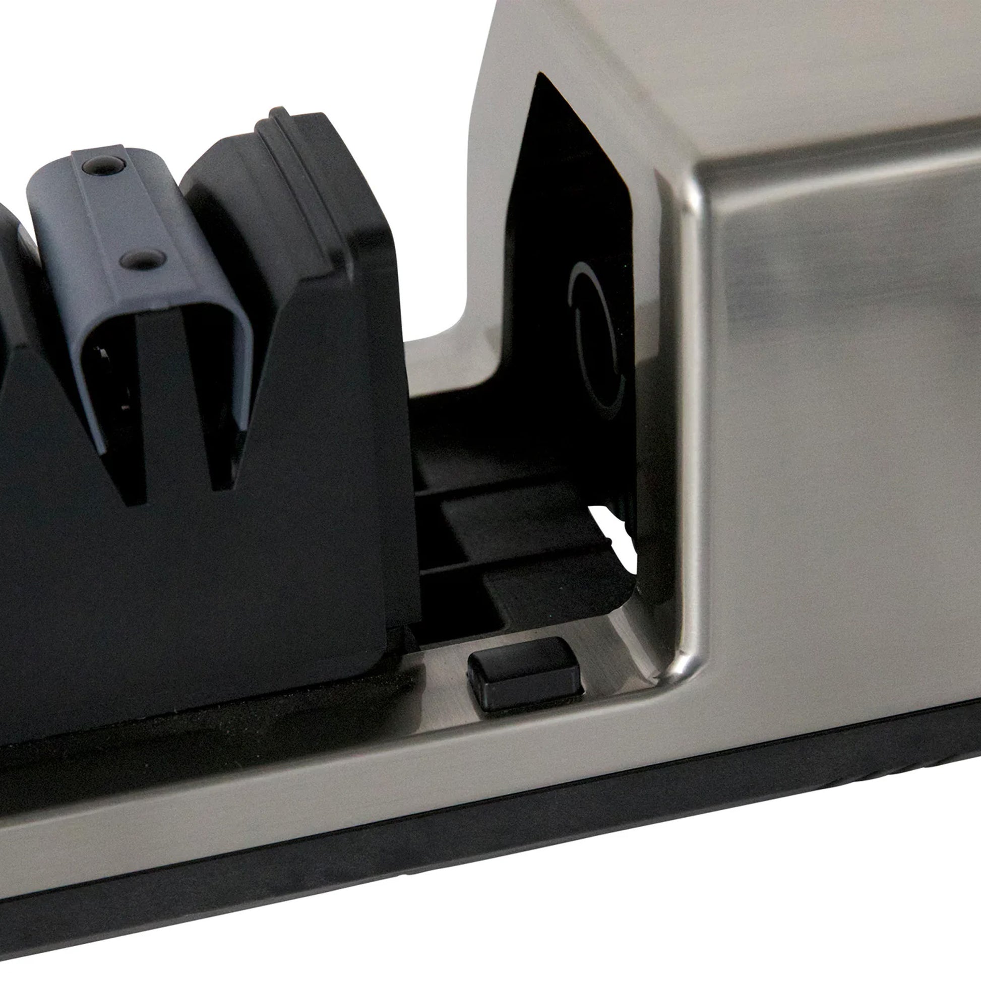Close-up of black sharpening guide openings in silver housing on knife sharpener